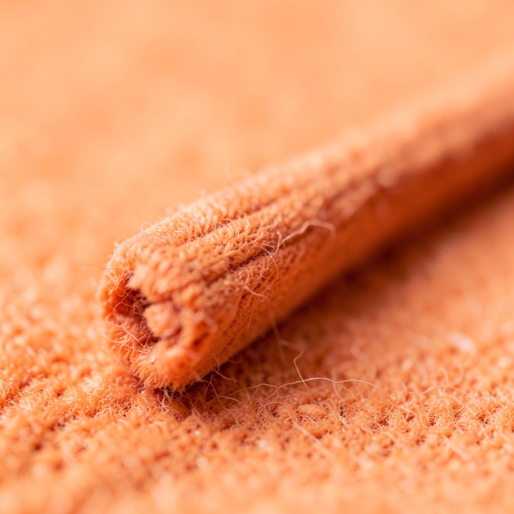 Warm sandy-brown textured background with subtle highlights and shadows, conveying an earthy, archival mood.